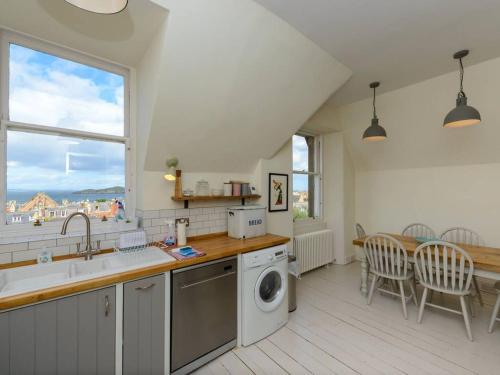 a kitchen with a sink and a washing machine at Forthview in North Berwick