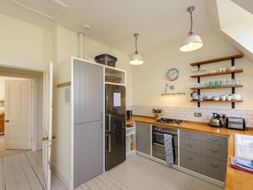a kitchen with a stainless steel refrigerator and cabinets at Forthview in North Berwick