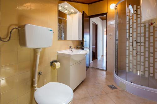 a bathroom with a toilet and a sink and a shower at Apartments Matilda in Dramalj