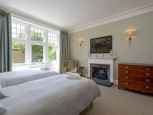 a bedroom with two beds and a fireplace at Havana in North Berwick