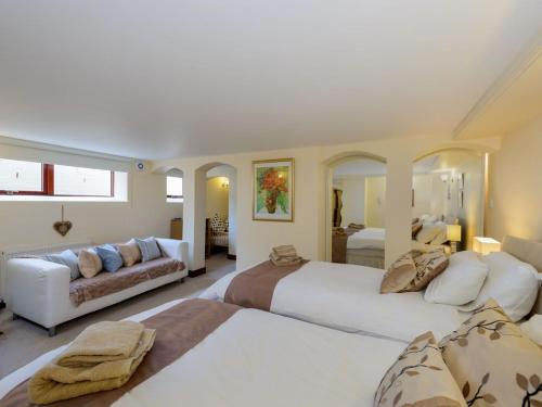 a large bedroom with two beds and a couch at Harmony Undercroft in North Berwick
