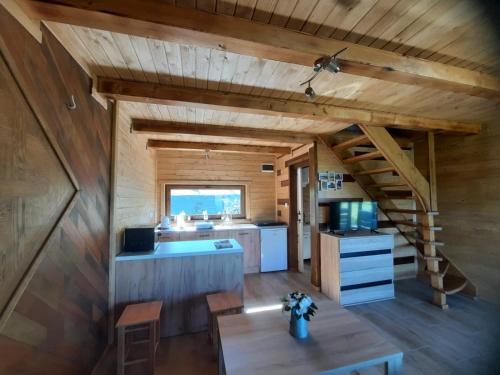 a kitchen with a staircase in a tiny house at Domki Dwa in Limanowa