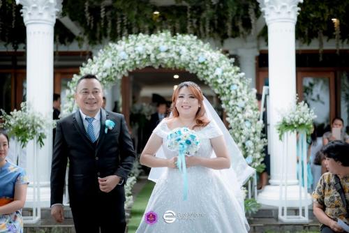 a bride and groom walking down the aisle at Keraton Krakatoa in Banten