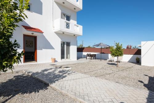 a large white building with a patio in front of it at Casa Marinella in Gennadi