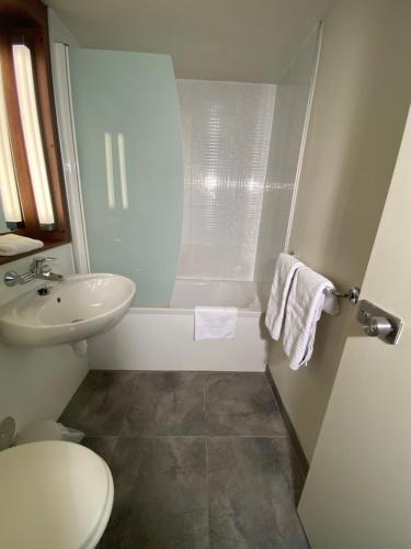 a bathroom with a sink and a toilet and a tub at Campanile Nantes ~ Rezé Aéroport in Rezé