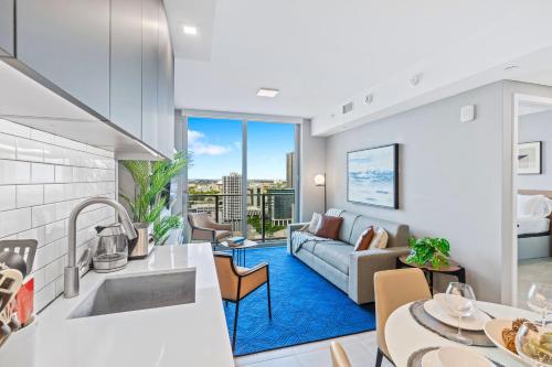 a kitchen and living room with a couch at - Casiola Studio's - near Cruise Terminal, Bayfront Park and Kaseya Center in Miami