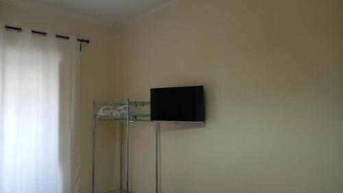 a flat screen tv on a wall in a room at Hotel Eliseo Napoli in Naples