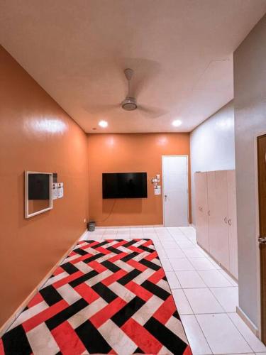a living room with a rug on the floor at Mekming Lodging - Homestay in Melaka