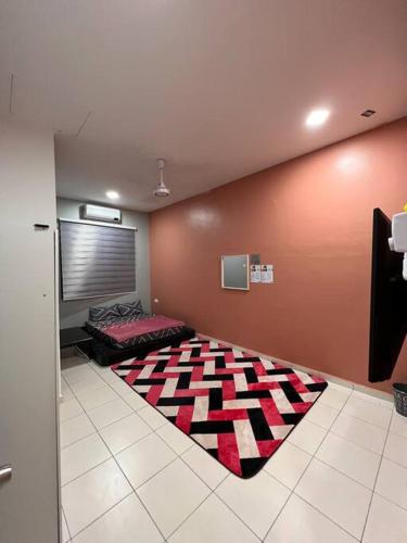 a room with a bed and a rug on the floor at Mekming Lodging - Homestay in Melaka