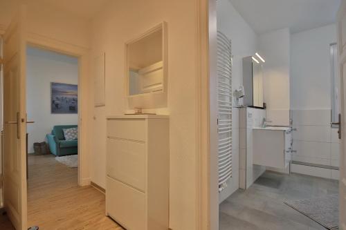a room with a hallway with a refrigerator and a kitchen at Hannas Strandhaus Hannas Strandhaus App B in Häven