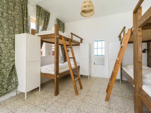 a room with two bunk beds and a ladder at Jungle House in Las Palmas de Gran Canaria