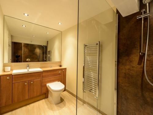 a bathroom with a toilet and a sink and a shower at Southcot in North Berwick