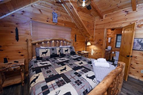 a bedroom with a bed in a log cabin at Bucking Bison - Pet friendly, mountain view, hot tub, game room, fire pit and more! in Mineral Bluff