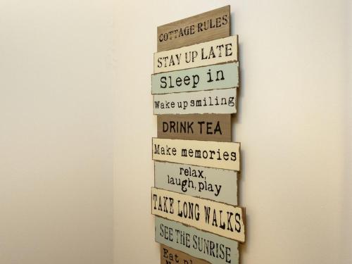 a group of wooden signs hanging on a wall at Springfield View in North Berwick