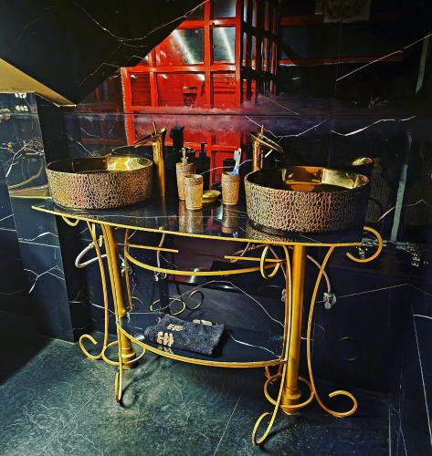 a table with two sinks on top of it at Super luxury Gold Room with private pool at Homestay by the tea garden Dibrugarh in Dibrugarh