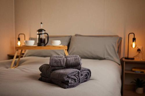 a bed with towels on top of it with a table at Nirvana Coastal Retreat Holiday Home in Cayton