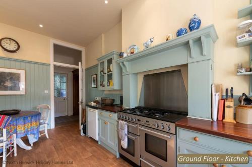 a kitchen with a stove and a counter top at St Colms Main House in North Berwick