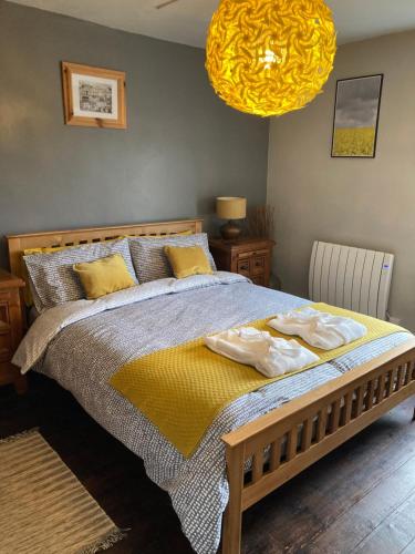 a bedroom with a bed with two towels on it at Top Floor at Cantref House in Brecon