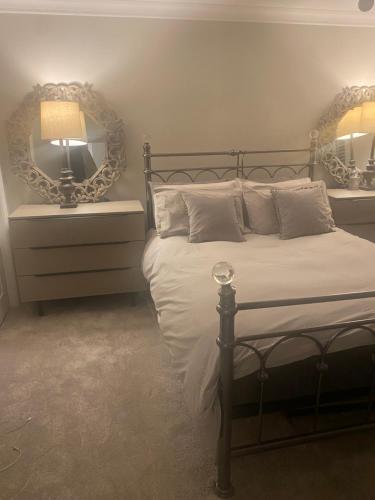 a bedroom with a bed with a lamp and a mirror at Greens Walk in Liverpool