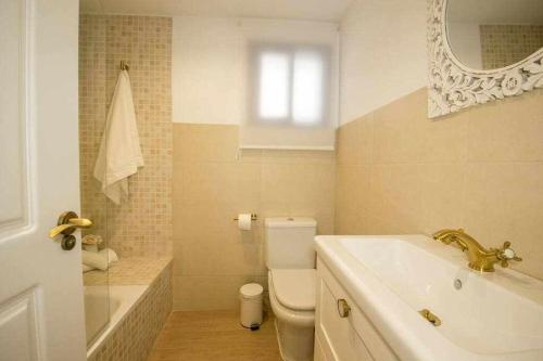 a bathroom with a sink and a toilet and a mirror at dúplex a la orilla del Mediterráneo in Torrox Costa