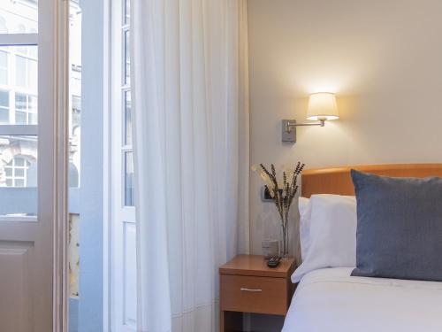 Voodi või voodid majutusasutuse Hostal ALBA Lugo toas