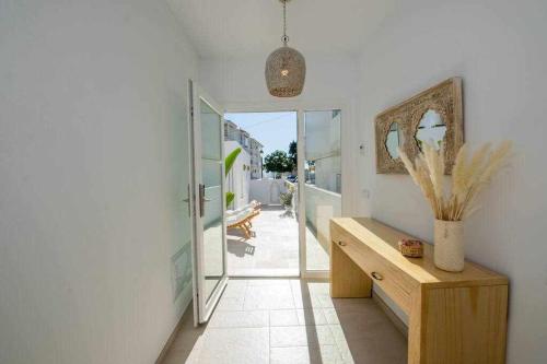 a room with a hallway with a table and a mirror at Marinero beach 2 in Torrox Costa