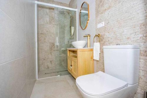 a bathroom with a shower and a toilet and a sink at Marinero beach 2 in Torrox Costa