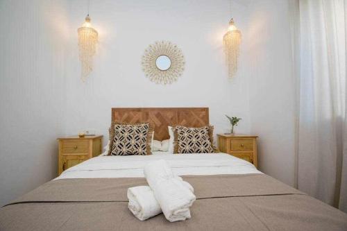 a bedroom with a large bed with two pillows at Marinero beach 3 in Torrox Costa