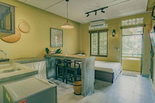 a kitchen with a sink and a bed in a room at Stay&Chill - S.4: Indochine loft nearby Bui Vien in Ho Chi Minh City