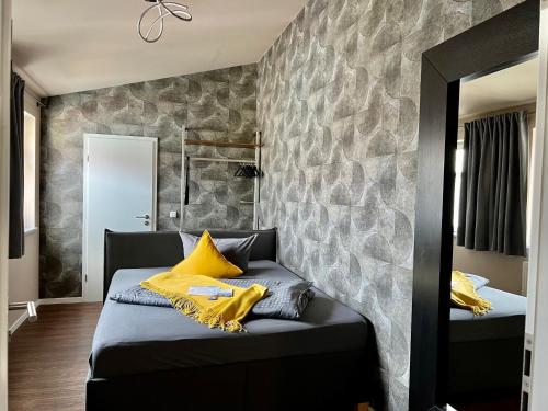 a bedroom with two beds and a stone wall at Altstadtpension am Dom in Erfurt