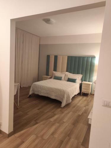 a bedroom with a bed and a wooden floor at Villa Cresto in Gaglianico