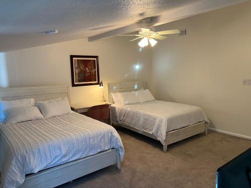 a bedroom with two beds and a ceiling fan at Large Bedroom With 2 Queen Bed in Charlotte