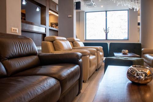 a waiting room with leather couches and a table at Panorama Hotel & Spa in Kruševo