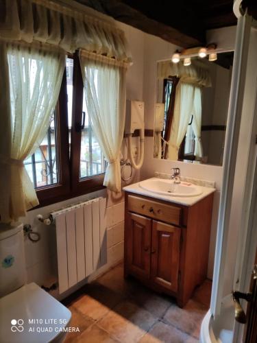 a bathroom with a sink and a mirror at CASA DE LOS ABUELOS in Espinama