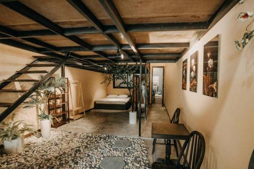 a room with a bed and a table and a desk at Stay&Chill - H.3 - Spacious loft near Ben Thanh in Ho Chi Minh City