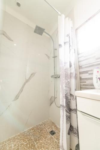 a bathroom with a shower and a sink at Aux portes de Lyon Tout confort emplacement idéale Netflix in Givors
