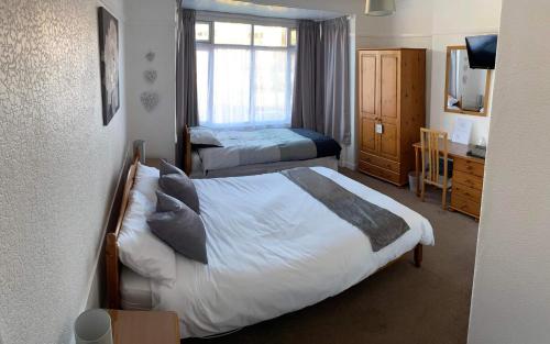 a hotel room with two beds and a window at Stepping Stones in Lincolnshire