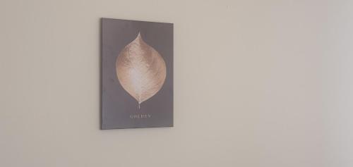 a leaf on a black picture frame on a wall at Coventry Park House in Parkside