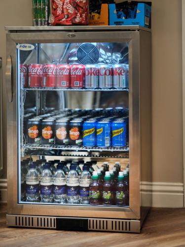 a refrigerator filled with lots of water and sodas at Linton Lodge a BW Signature Collection Hotel in Oxford