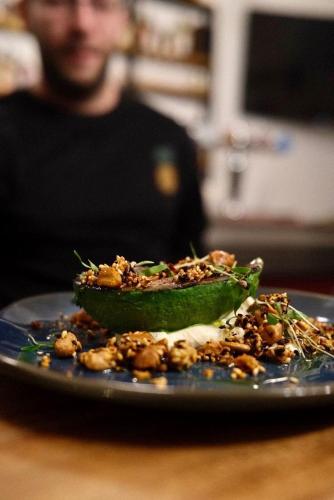 a plate with a green avocado on a table at Bar des Amis in Villars