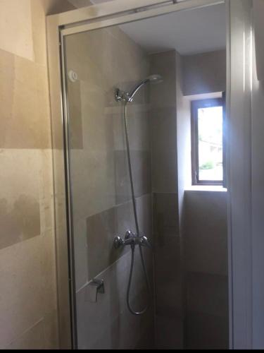 a shower with a glass door in a bathroom at APARTAMENTO Luis in Suances