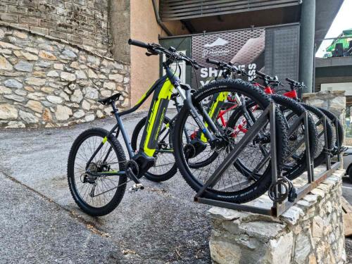 a bike is parked on a rack in front of a building at Panorama Hotel & Spa in Kruševo