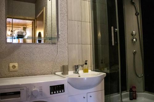 a bathroom with a sink and a shower at Rubeņi Jūrmala in Jūrmala