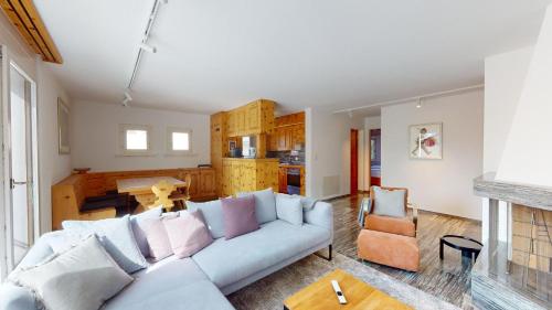a living room with a couch and a table at Abitaziun Curtins 1 6 - La Punt Chamues-ch in La Punt-Chamues-ch