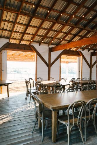 a dining room with wooden tables and chairs at Contigo Ranch Fredericksburg in Fredericksburg