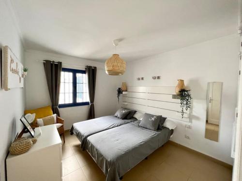 a bedroom with a bed and a couch in it at Casaloé in Puerto del Carmen