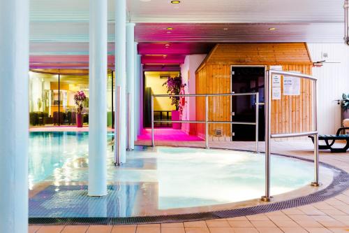 a swimming pool in a building with columns at New Lanark Self Catering Waterhouses in Lanark