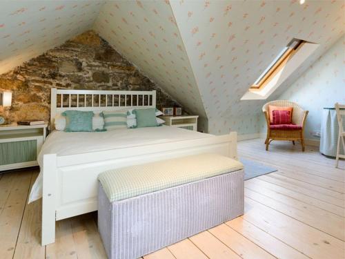a bedroom with a white bed in a attic at Nungate in North Berwick