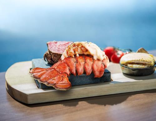 a plate of food with a lobster and a sandwich at Estérel Resort in Esterel