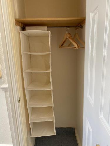 a closet with white shelves in a room at The Laurels in Blackpool